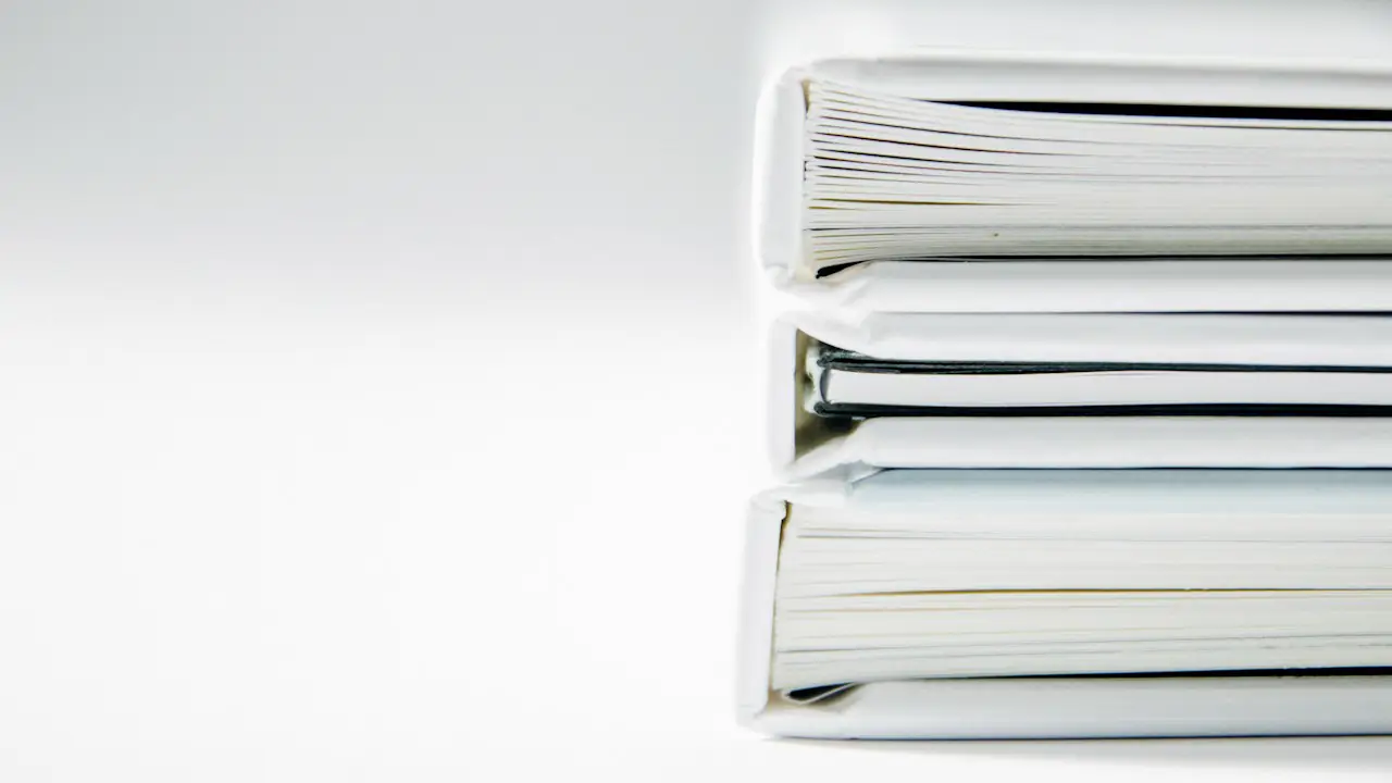 A neat stack of white binders