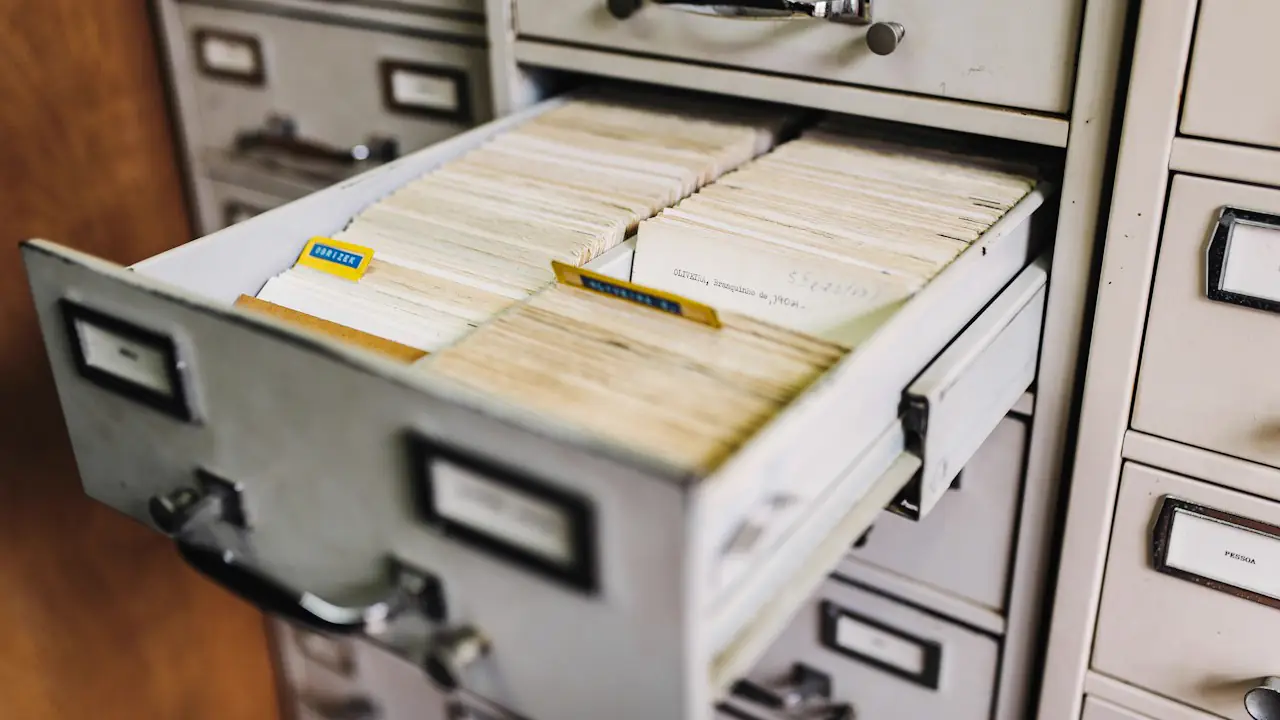 An open filing cabinet drawer full of index cards