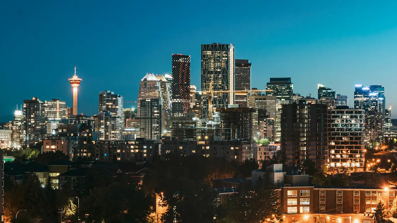 The Calgary skyline and Calgary Tower lit up at dusk