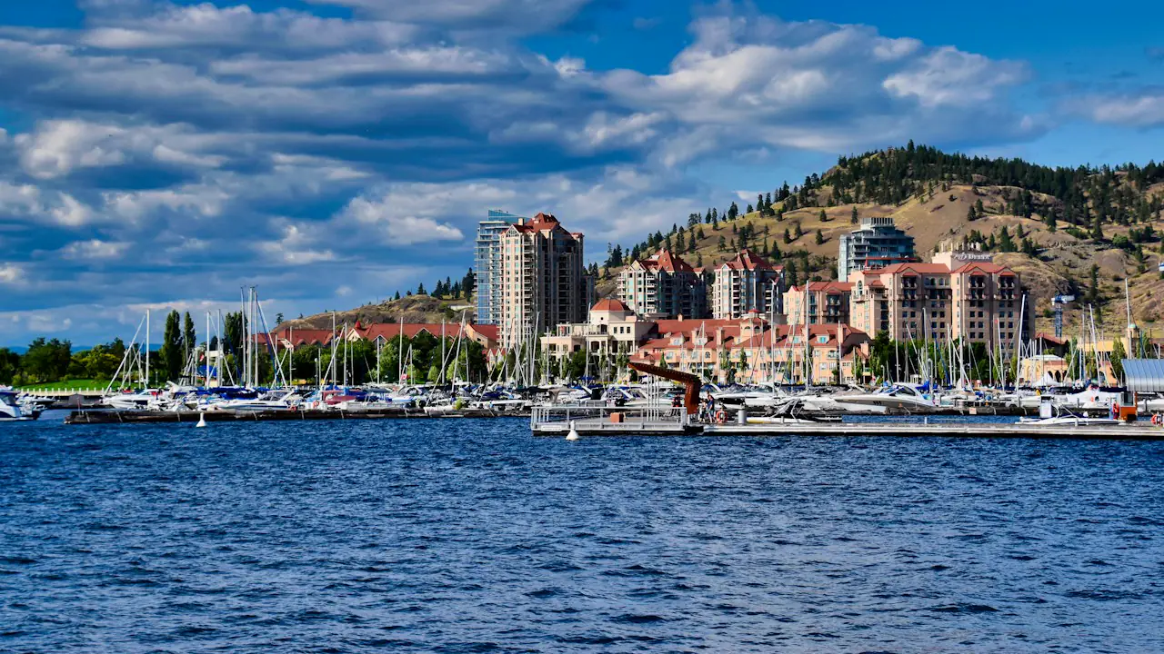The Kelowna waterfront and marina on the lake, with hills behind