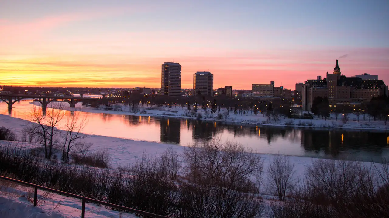 The Saskatoon skyline and river at sunset in winter