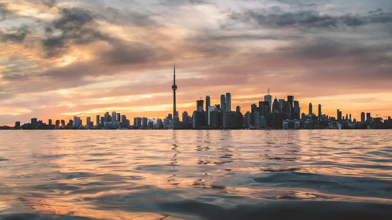 The Toronto skyline and CN Tower at sunset, seen across the water