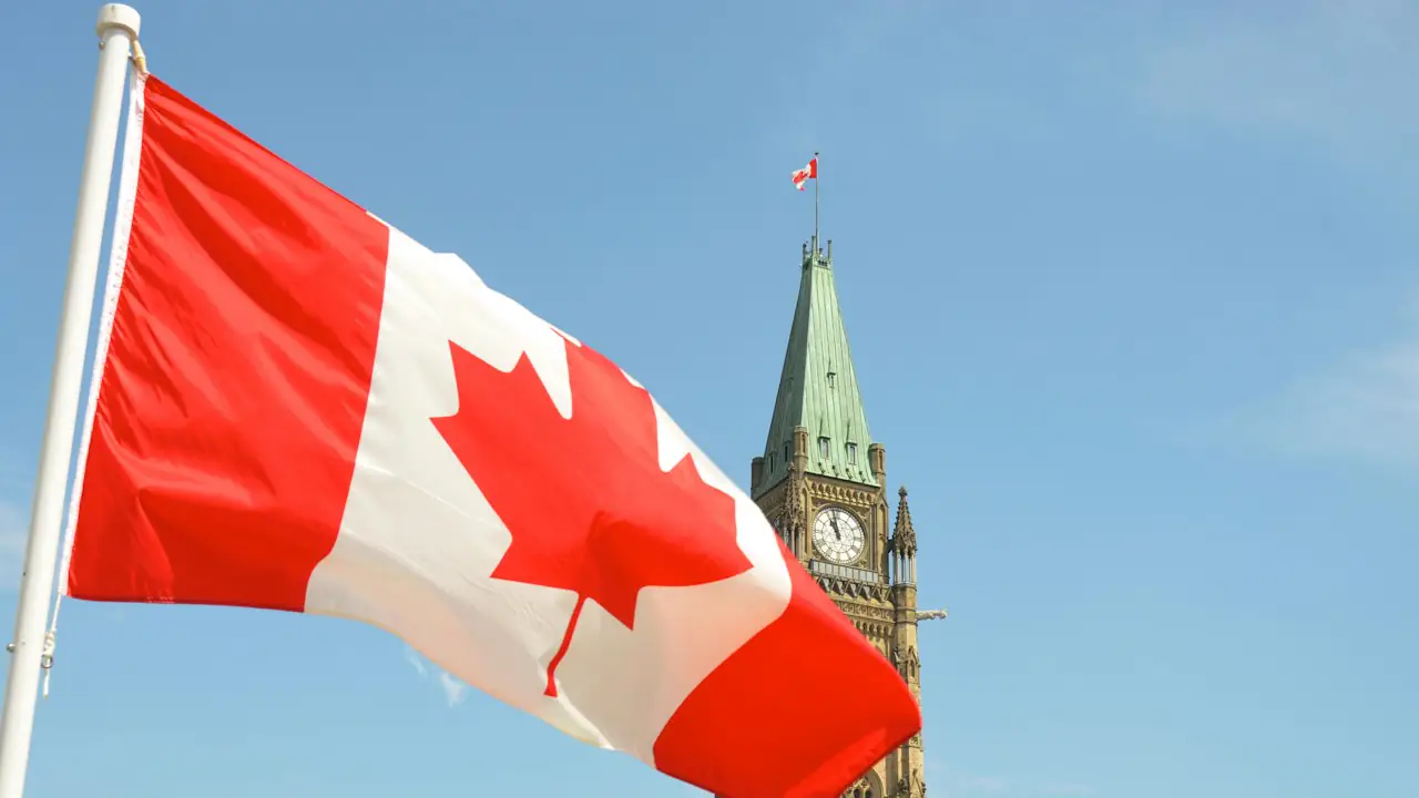 The Canadian flag flying in front of the Peace Tower in Ottawa