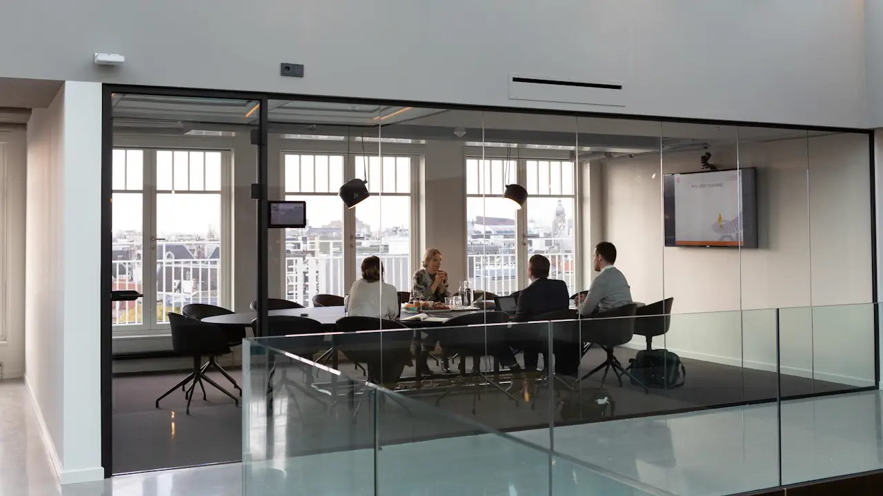 A meeting under way in a glass walled conference room