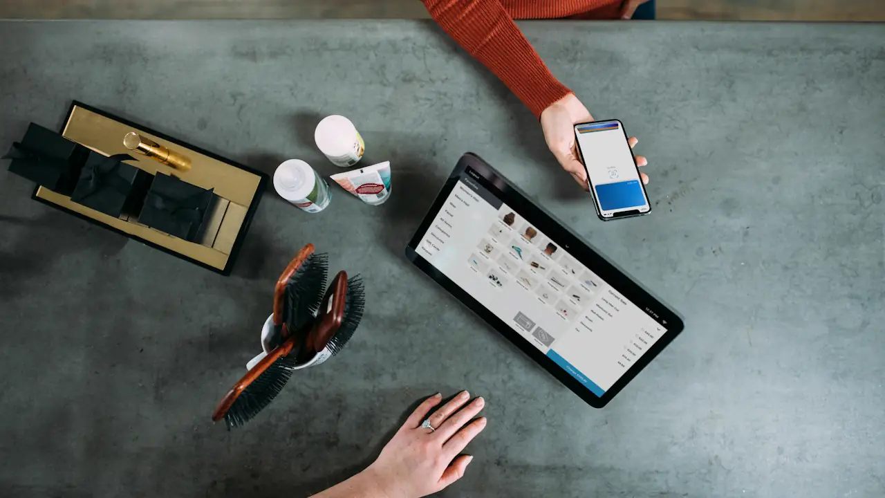 A customer paying by phone at a tablet checkout counter