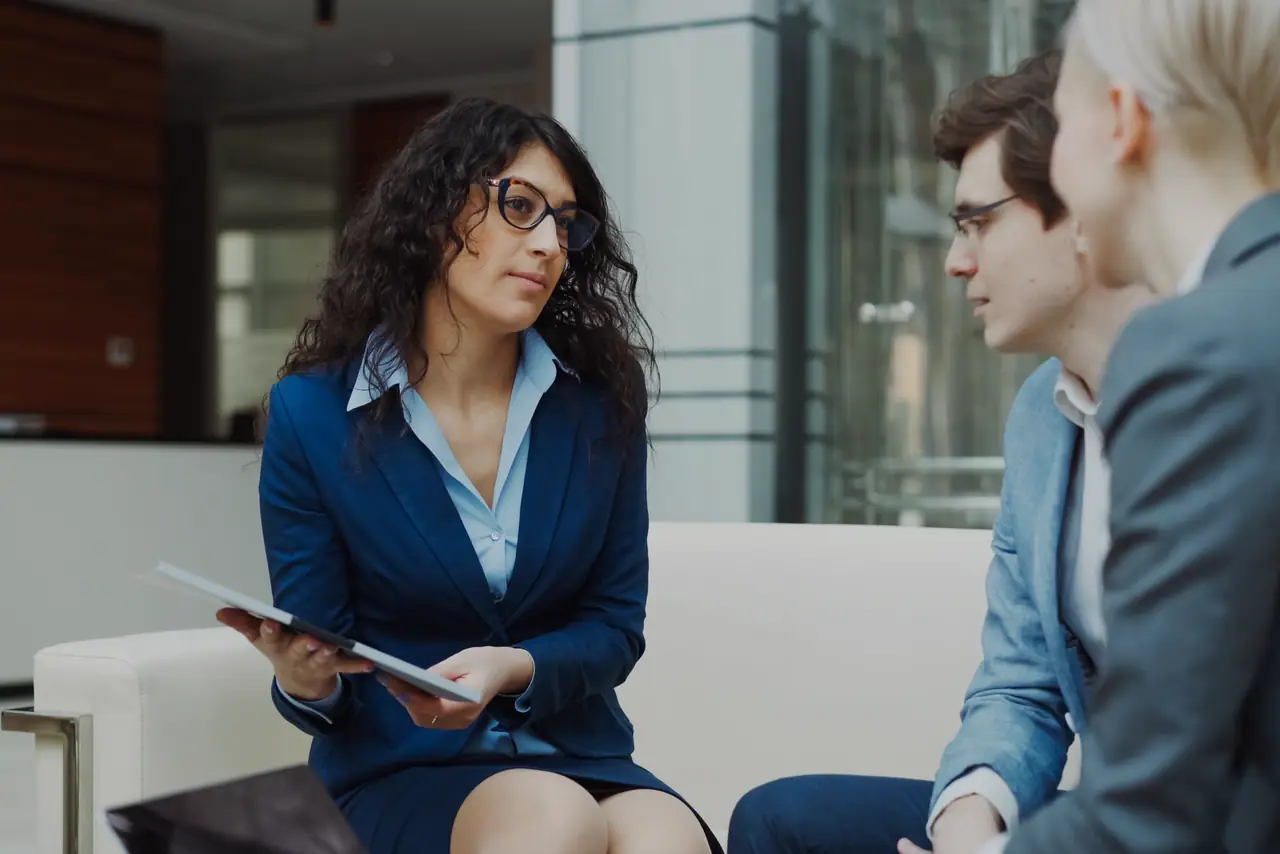 Small team discusses business plans around a table in a modern office