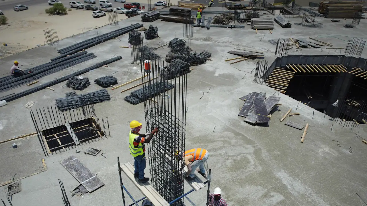 Aerial view of construction workers placing rebar on a concrete site