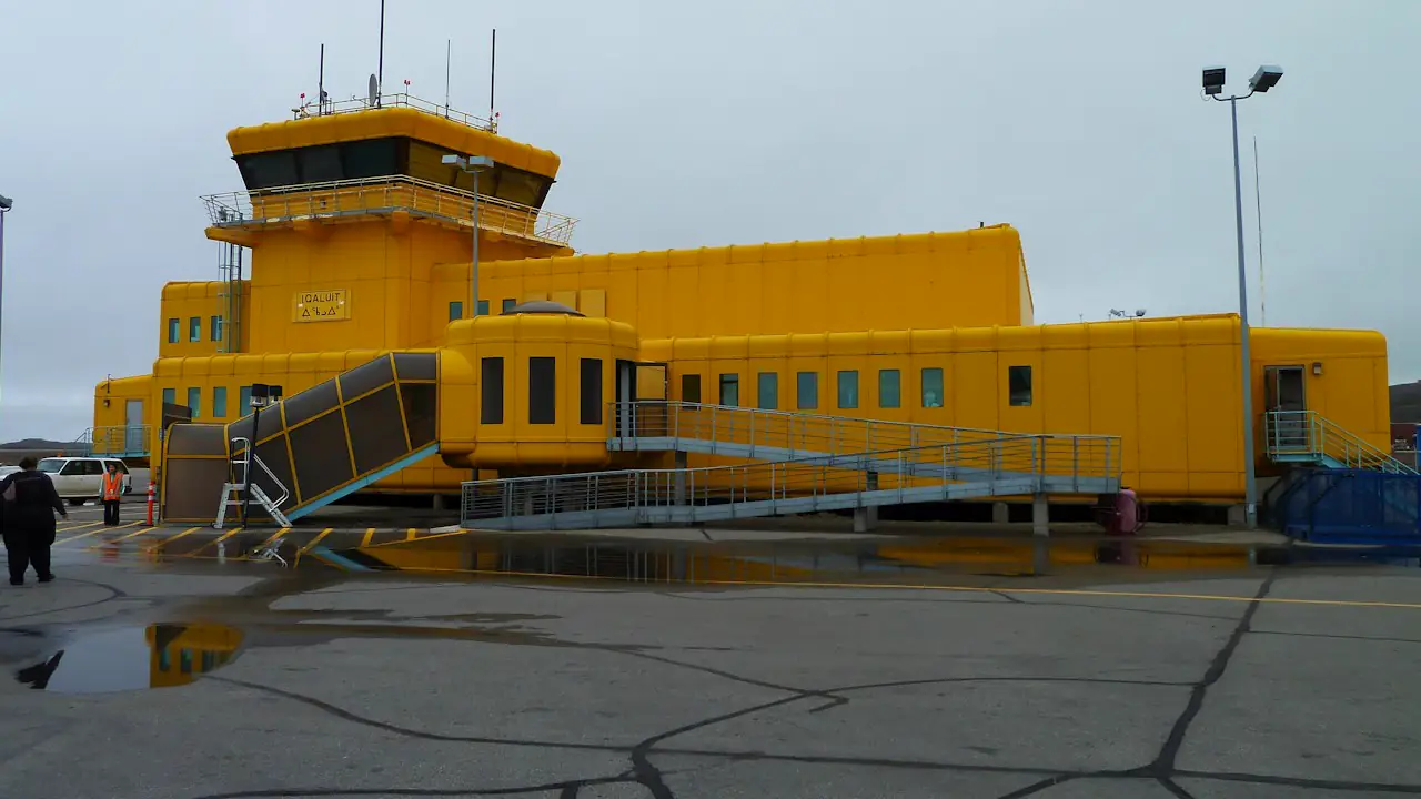 The bright yellow airport building in Iqaluit on an overcast day
