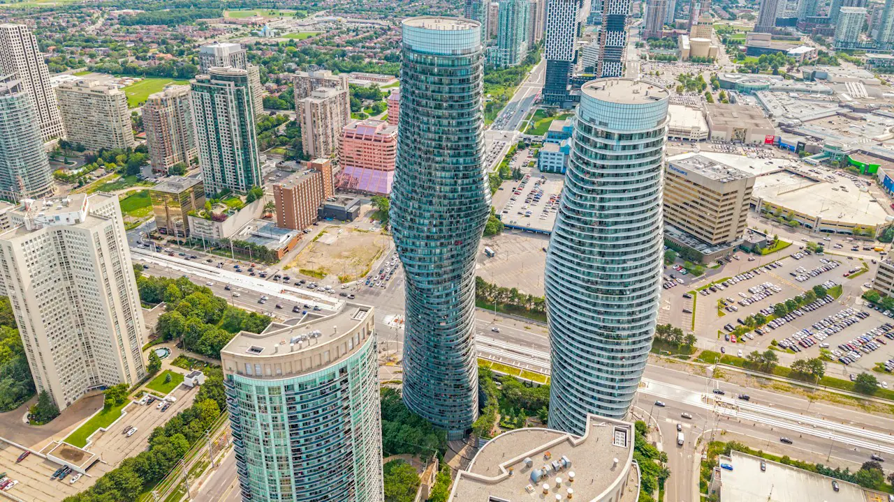 The curved Absolute World towers rising above Mississauga's city centre, seen from the air