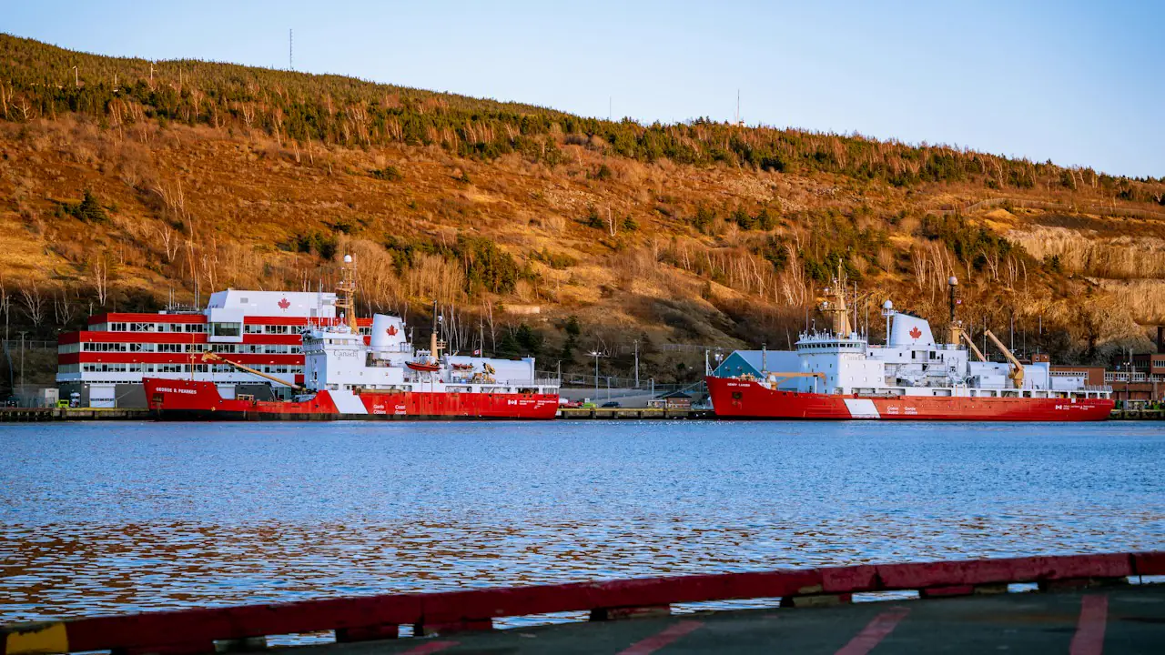 Red and white Coast Guard ships tied up in the harbour at St. John's