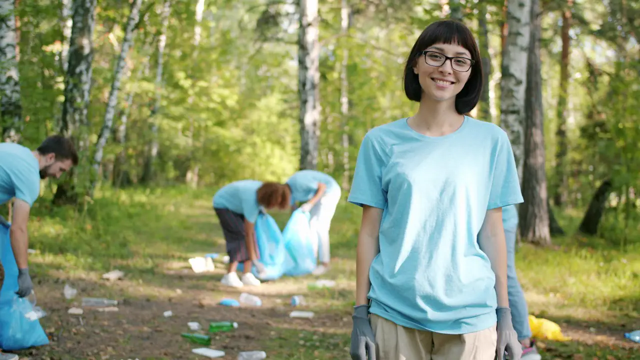 A smiling volunteer at a park cleanup