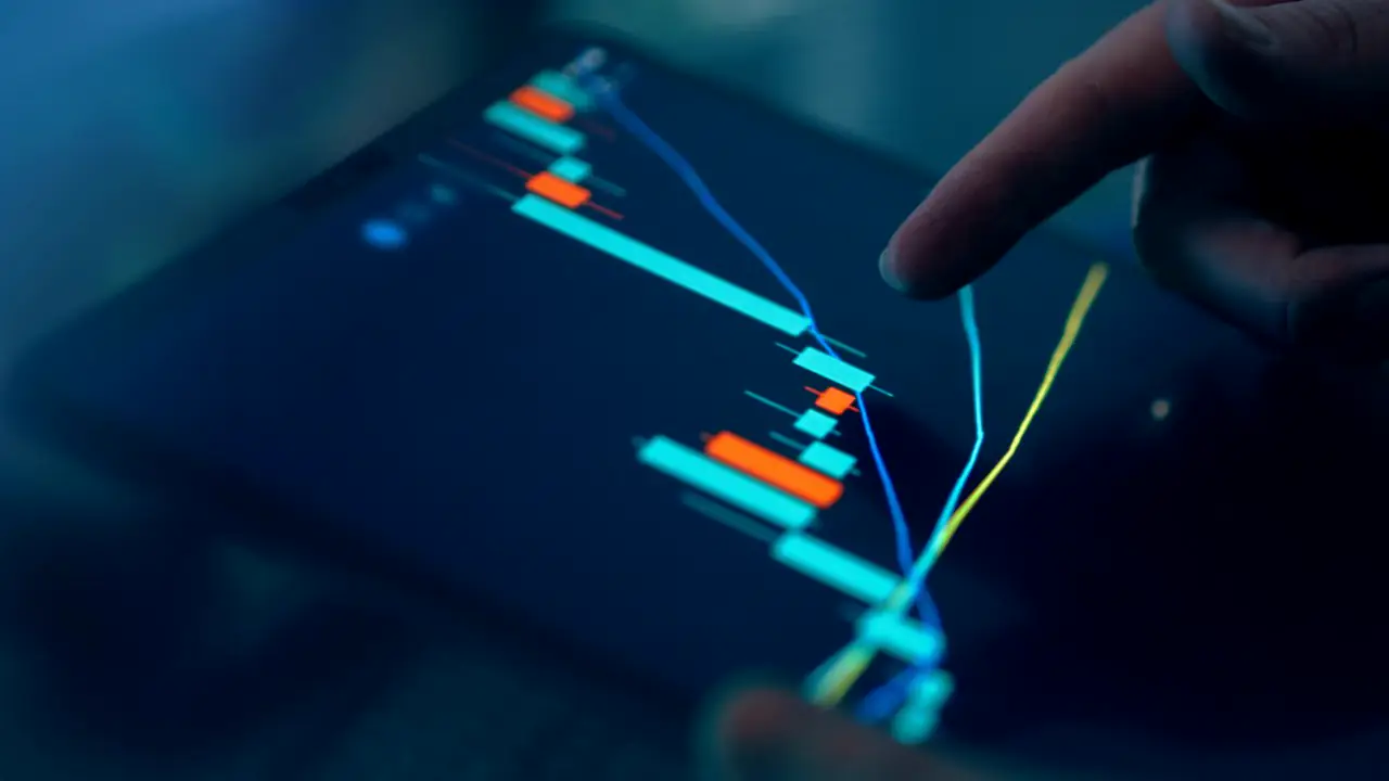 A finger tracing a glowing market chart on a tablet