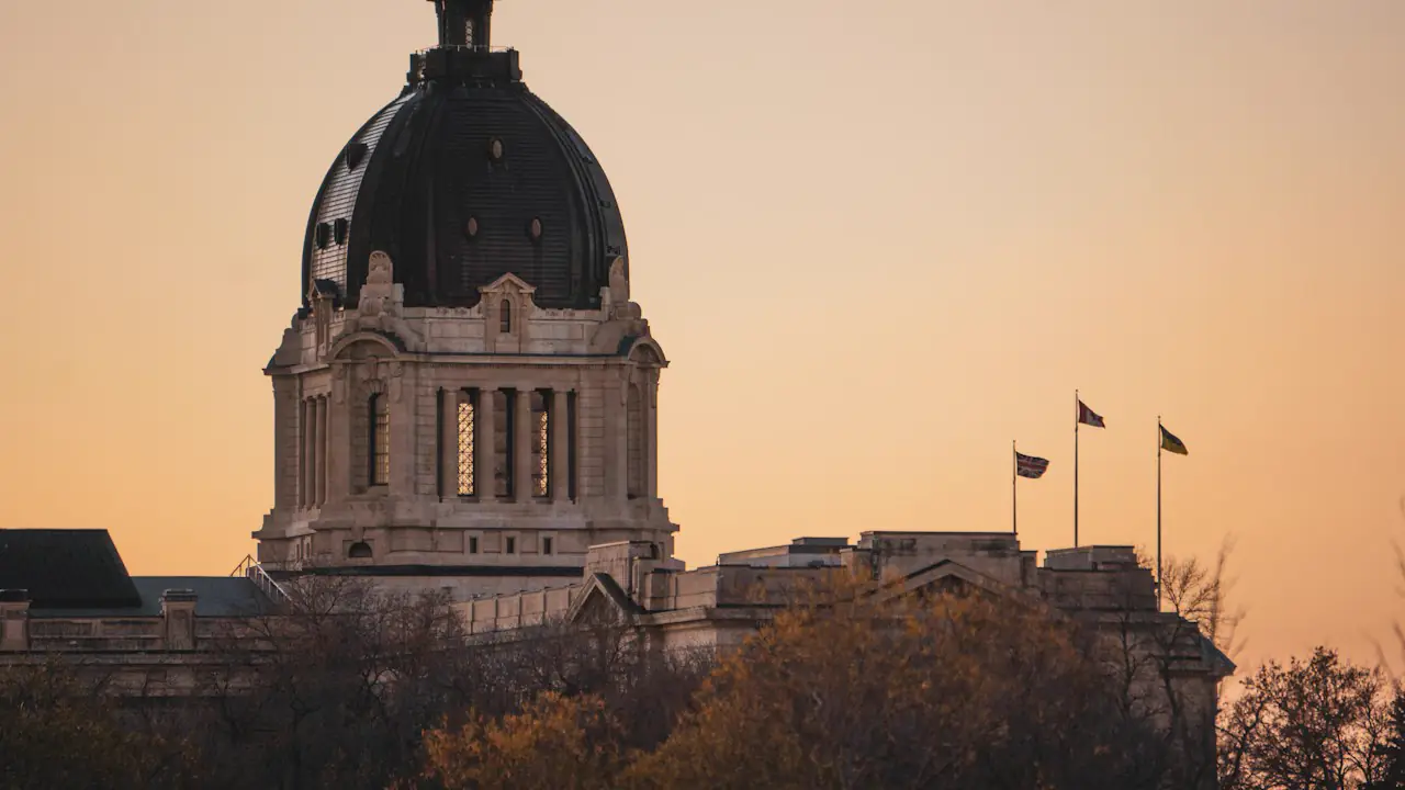The dome of the Saskatchewan Legislative Building against an amber evening sky