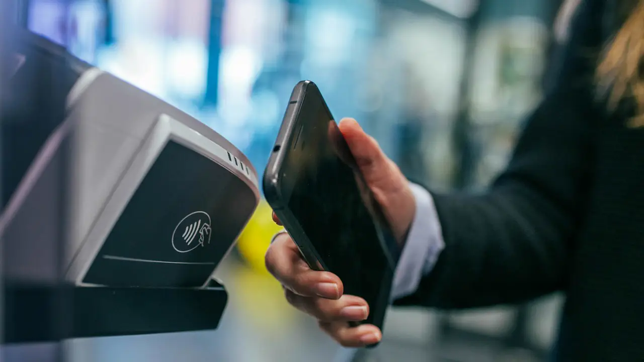 A phone held to a contactless payment terminal