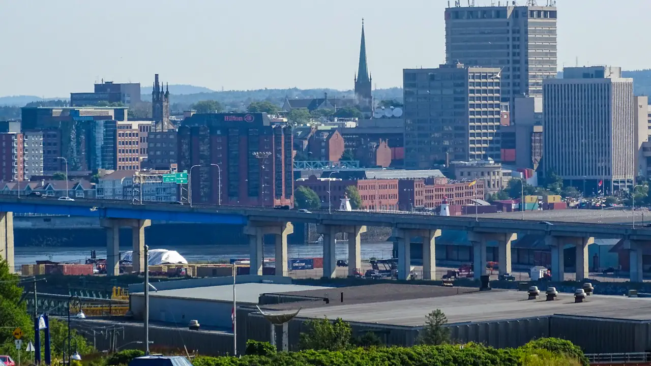 Uptown Saint John's office towers and church spires rising behind an elevated highway