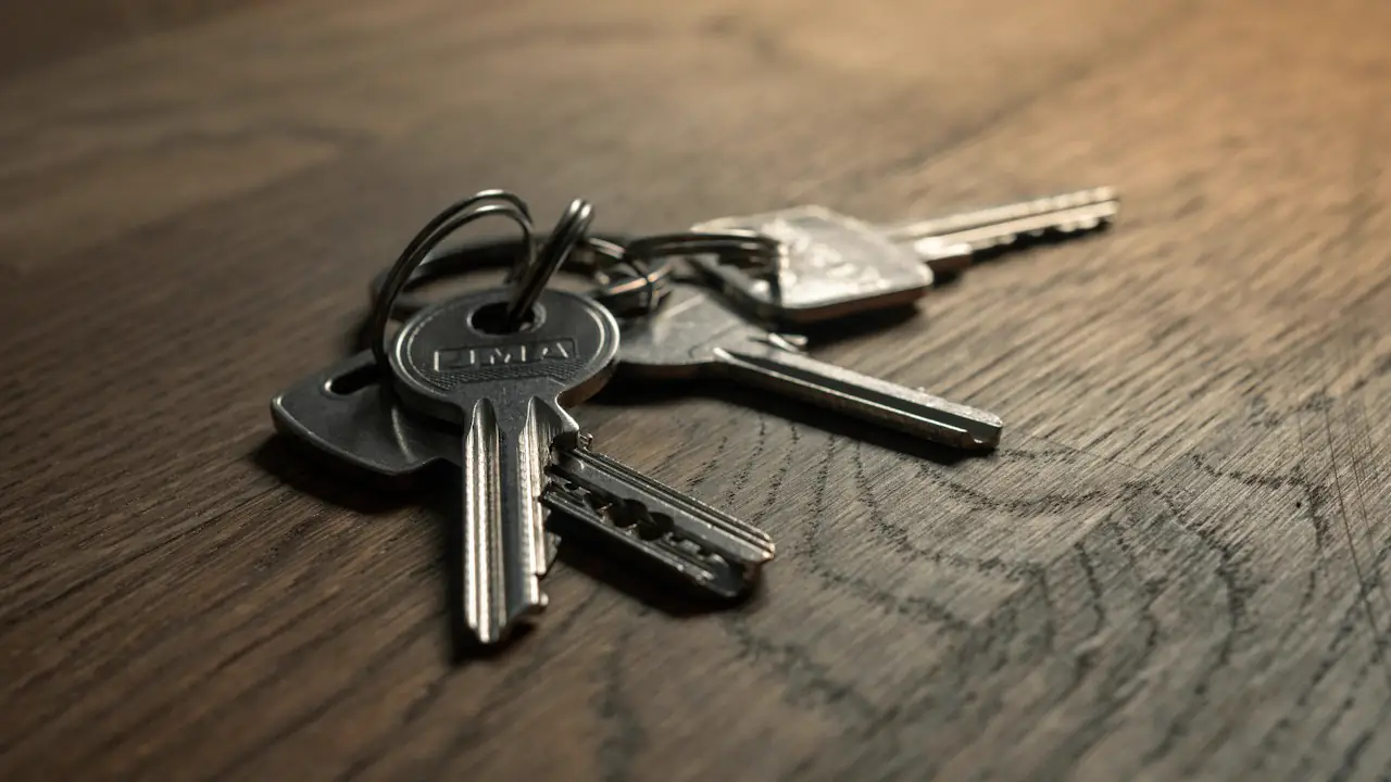 A set of keys on a wooden table