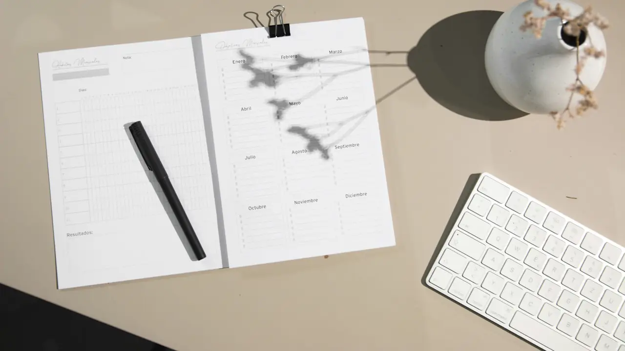 Papers, a pen and a keyboard on a desk