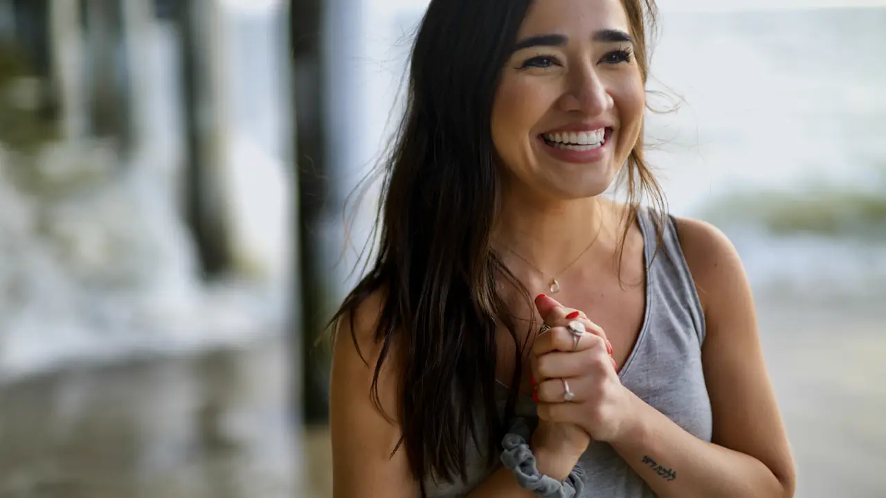 A woman smiling with relief outdoors