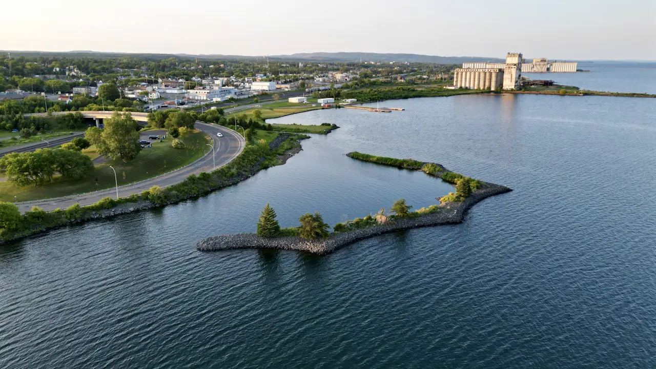 Thunder Bay's waterfront from the air, with a breakwater, a grain elevator and Lake Superior beyond