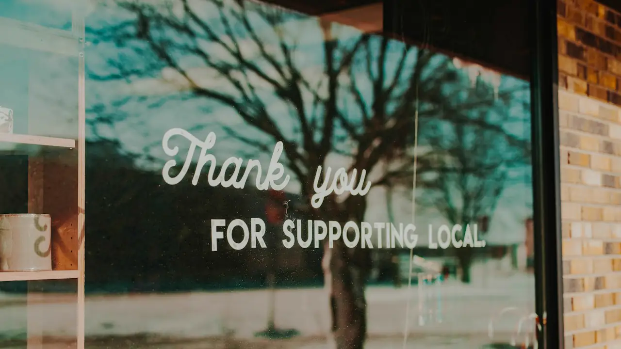 A shop window lettered with a thank you for supporting local
